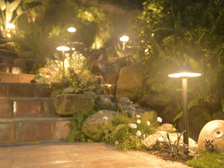 LED and halogen landscape lighting side by side in outdoor garden
